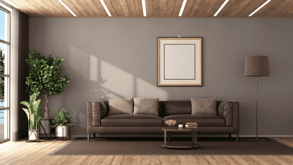 A brown leather sofa looks great with a tan wall