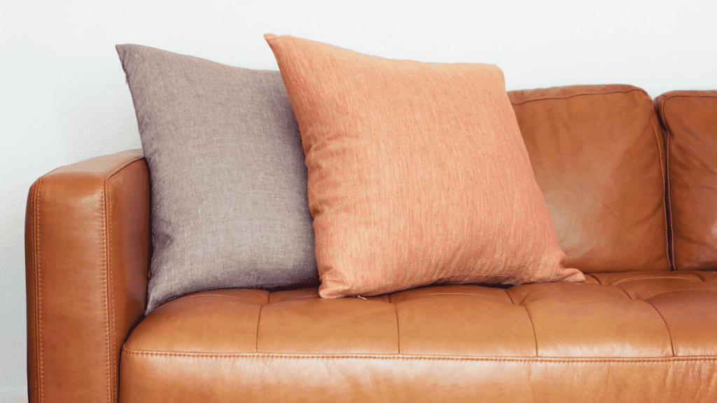 Brown and orange can look great with a brown leather sofa